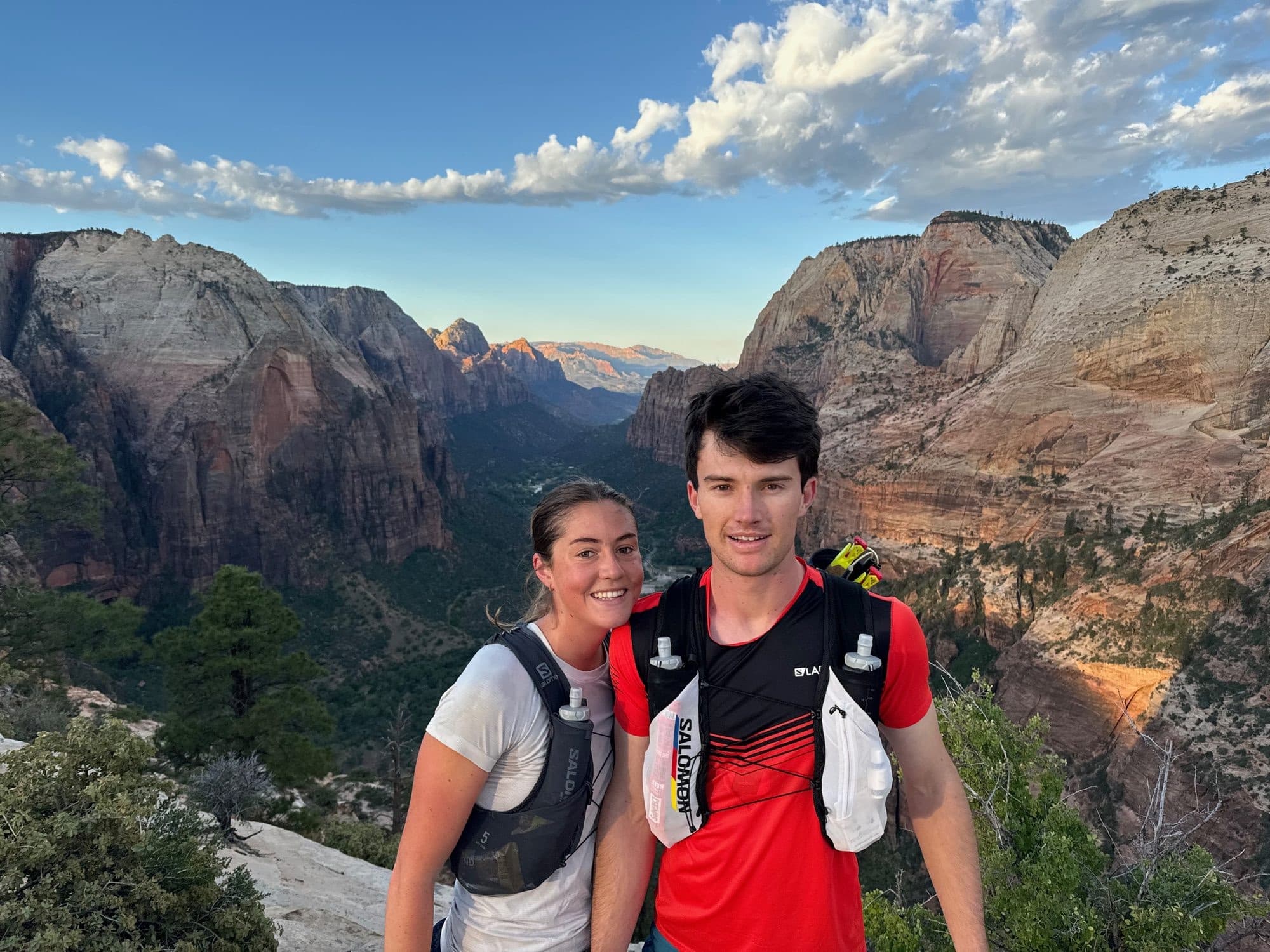 Audrey and Ben on the rim above a red rock canyon